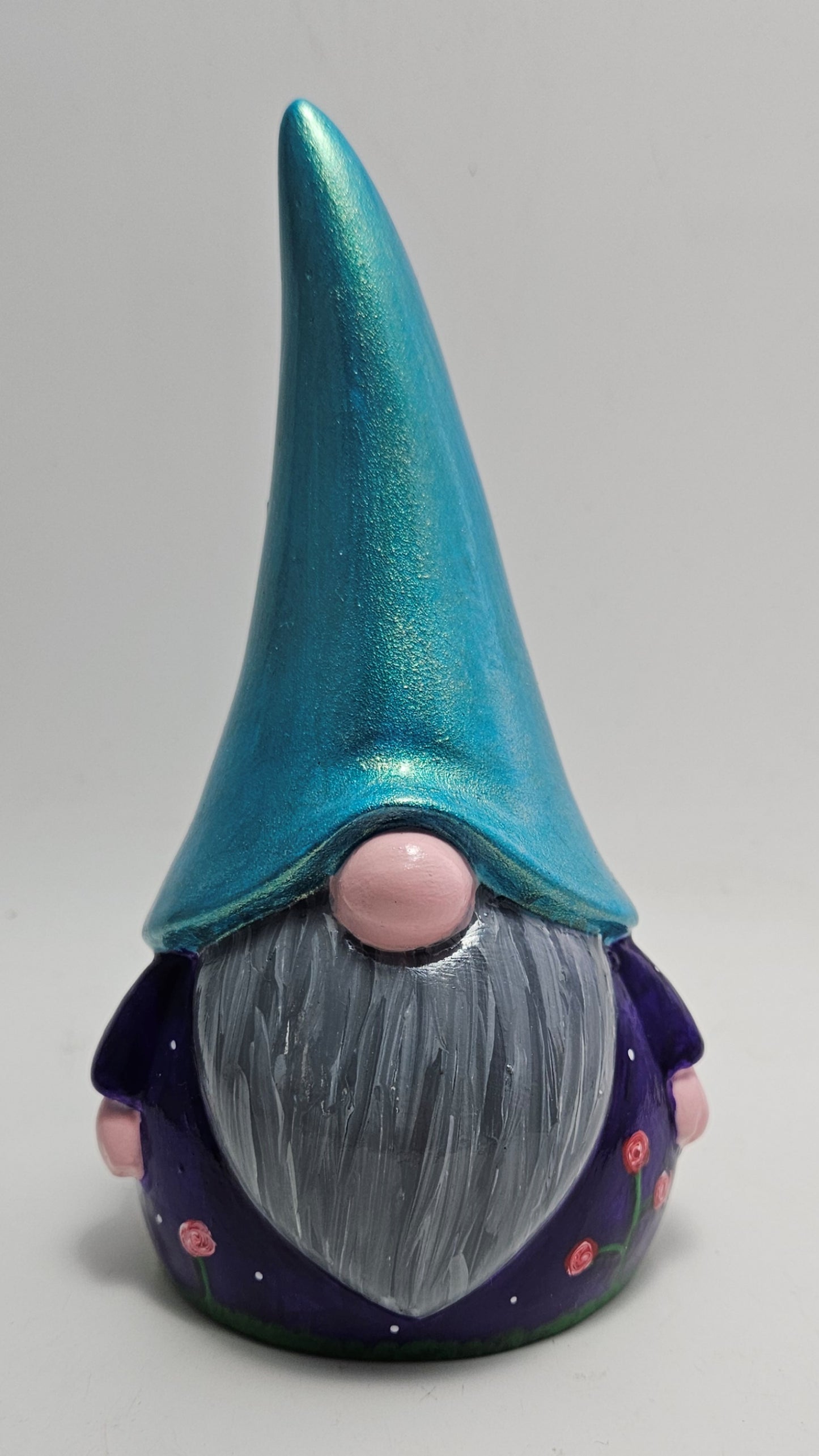 A whimsical figurine named Harry Gonk with a green hat, blue body, and grey beard, set against a neutral background.