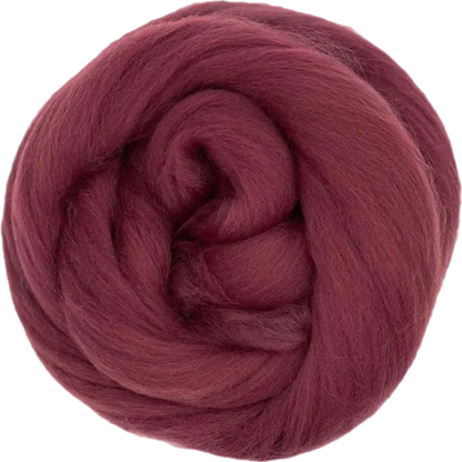 Ball of dark red yarn on a white background